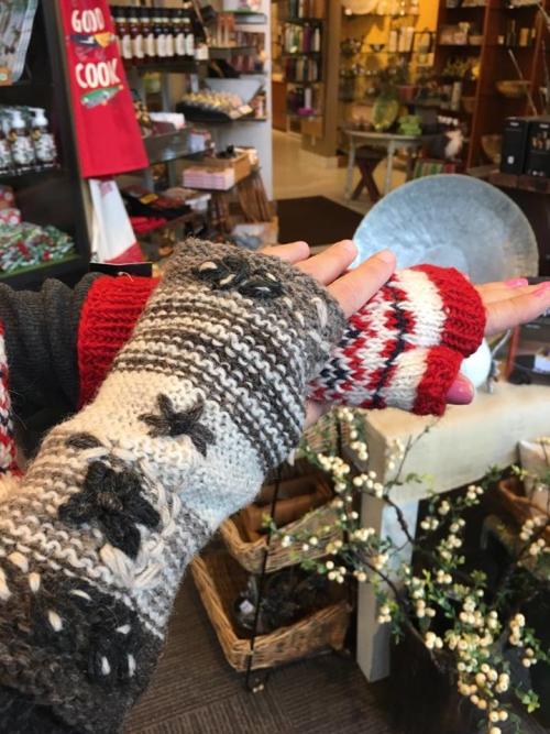 Two hands trying on fingerless knit gloves at GoodThings in Maple Grove