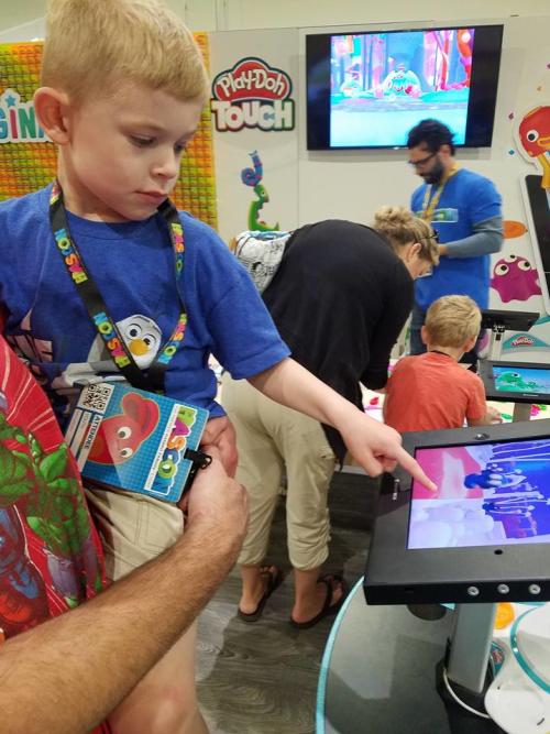 Boy using PlayDoh Touch pad at HASCON in Providence