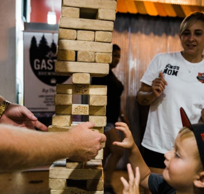young boy playing giant jenga game at Gaston Brewery