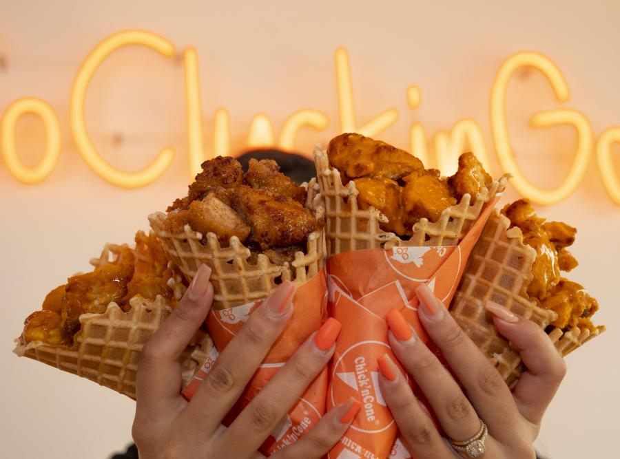 Woman holding 4 Chick 'n Cones