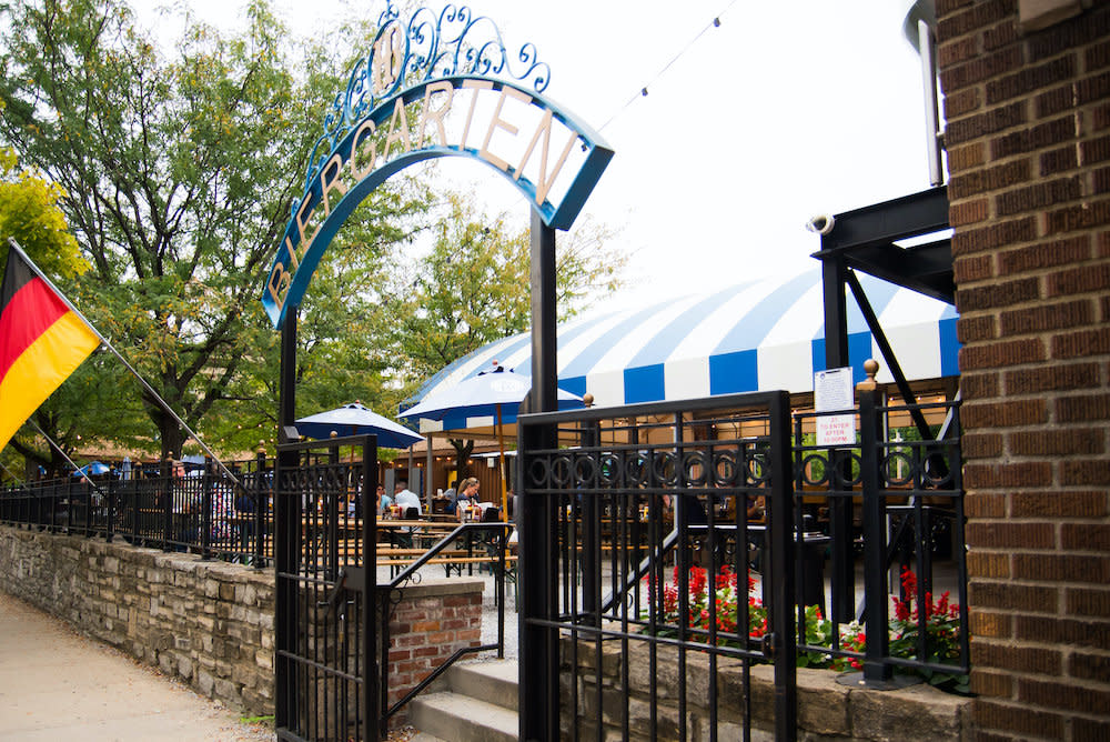 The entrance to the Hofbrauhaus Biergarten in Newport features an iron fence and festival seating, as well as a German flag