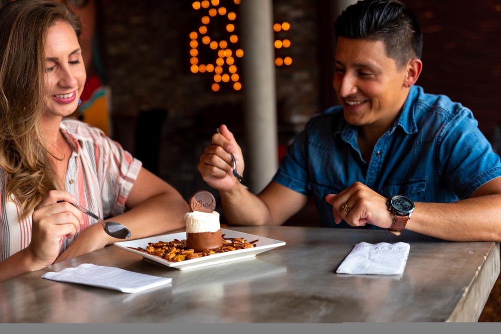 man and woman share an ice cream sundae