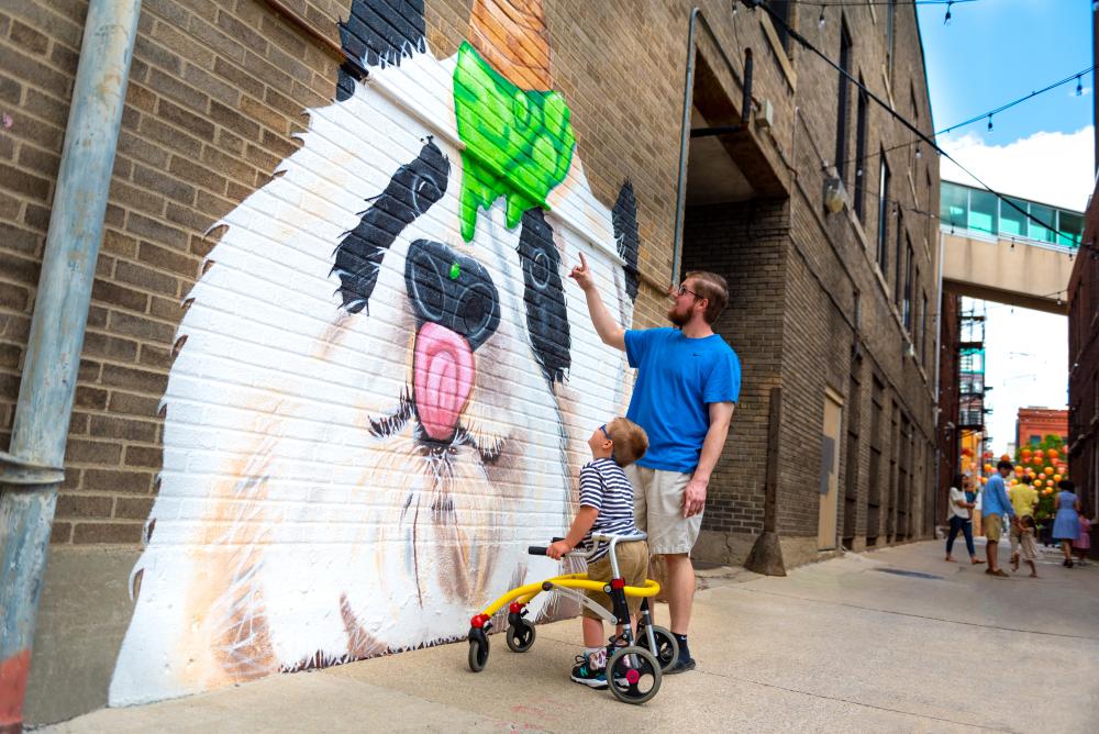 Father and son enjoying the panda mural in Fort Wayne, Indiana.