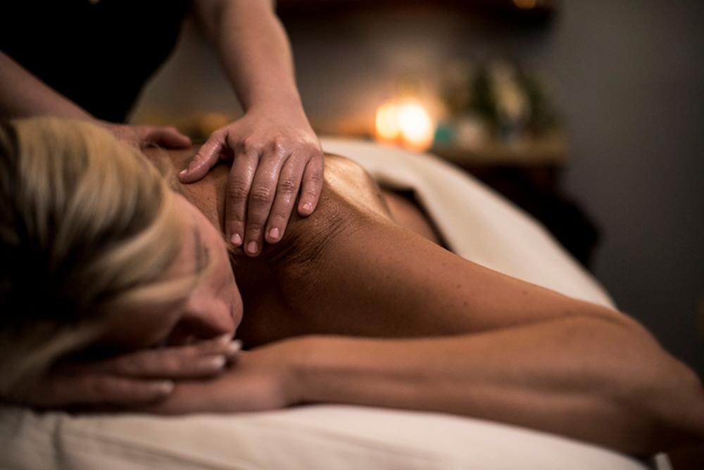 A women getting a massage at the Well Spa at Grand Geneva Resort.