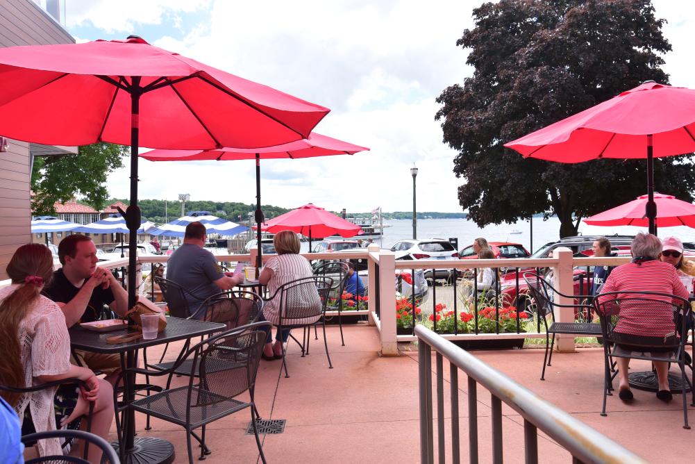 People dining outside by the lake