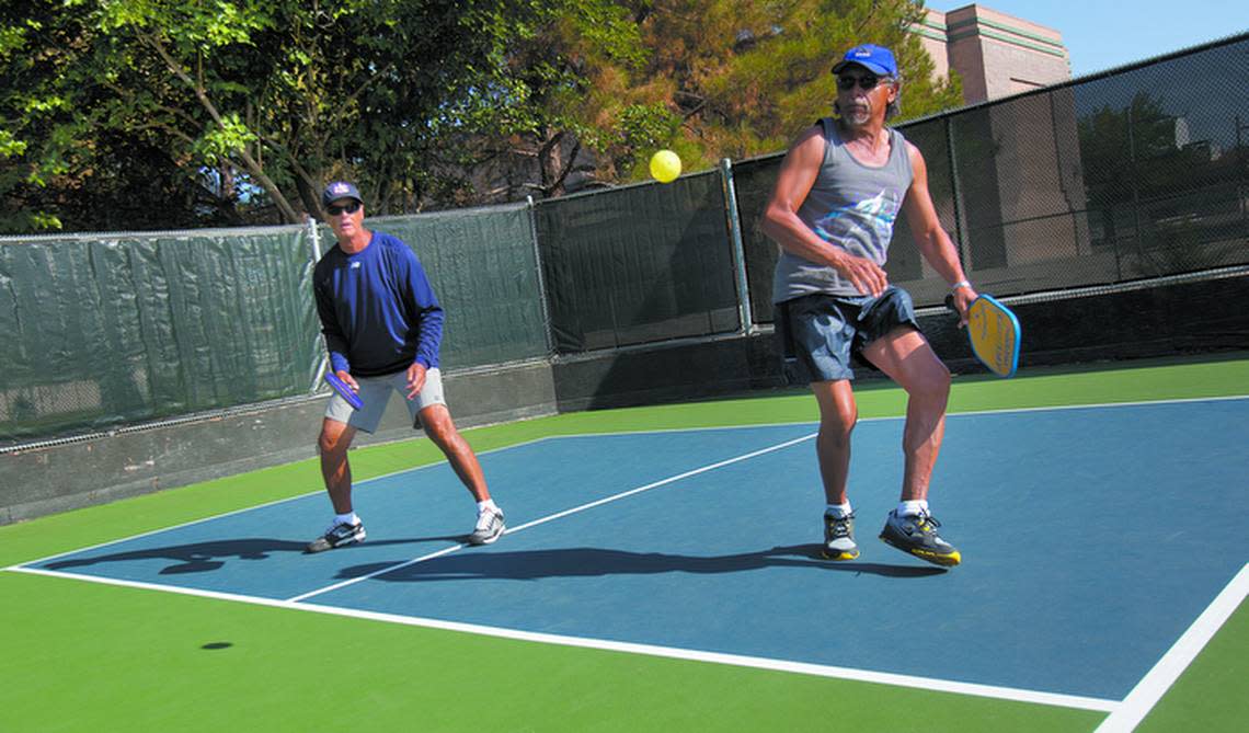 two men playing pickle ball on court in Paso Robles