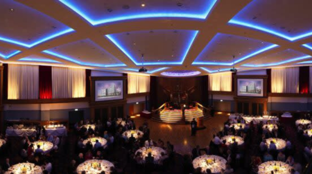 People at a conference in Belfast sitting at their tables.