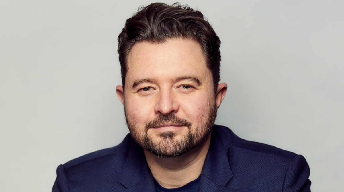 Daniel Priestley smiling wearing a suit