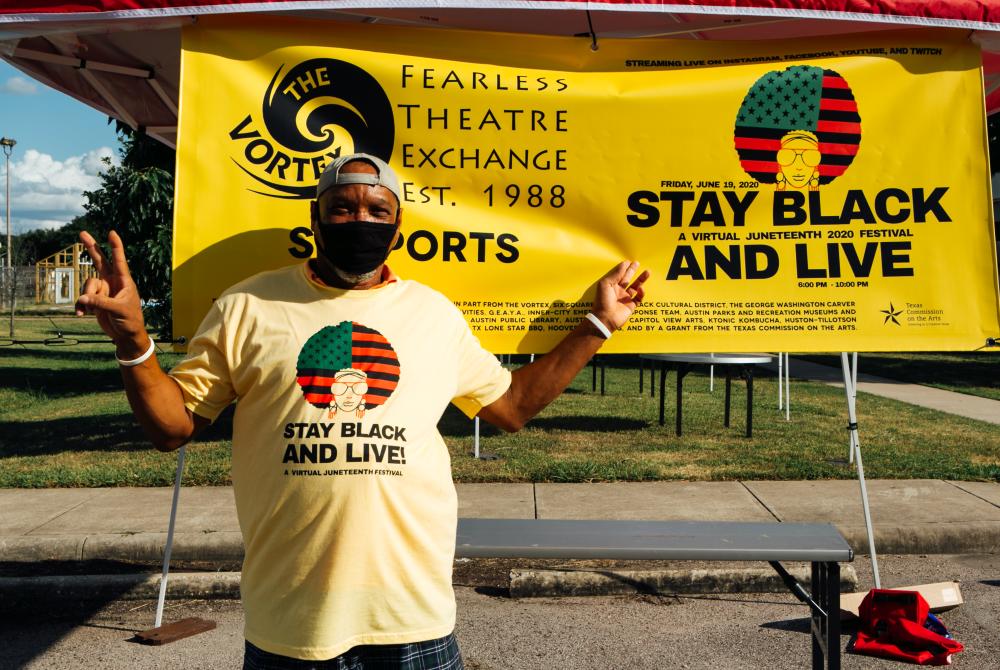 Man hold up peace sign in front of Juneteenth Stay Black and Live Event poster