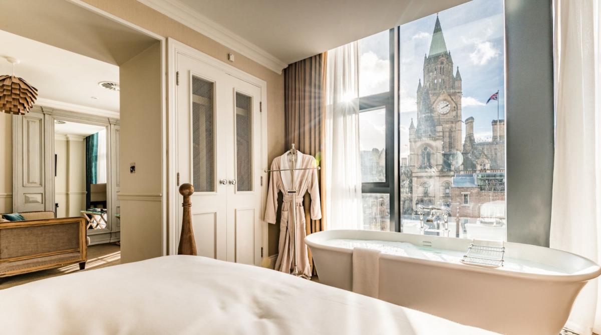 Hotel bedroom with bathtub and view to Manchester Town Hall