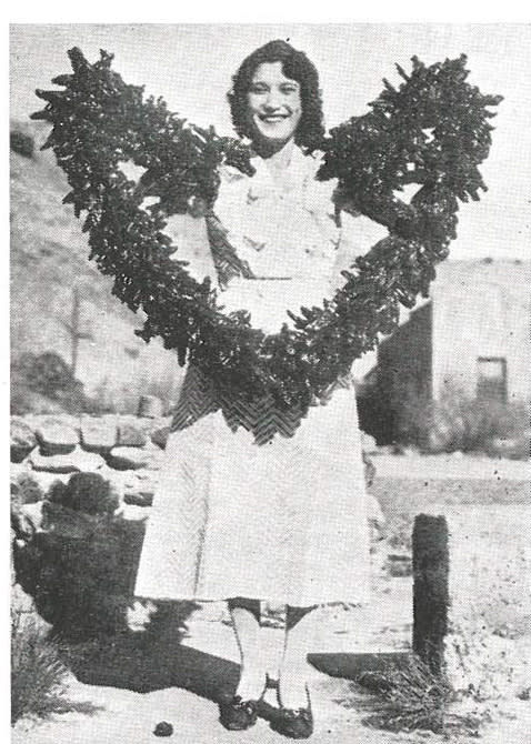 Woman holding a string of chile pods from May 1935 issue.