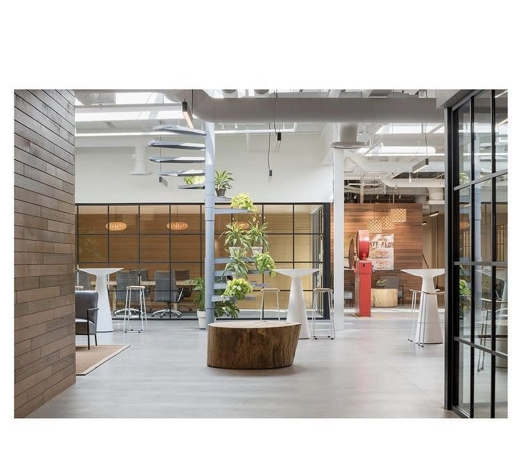Indoor meeting venue at Hula Lakeside, featuring high ceilings, earthy decor, and an open concept seating area.