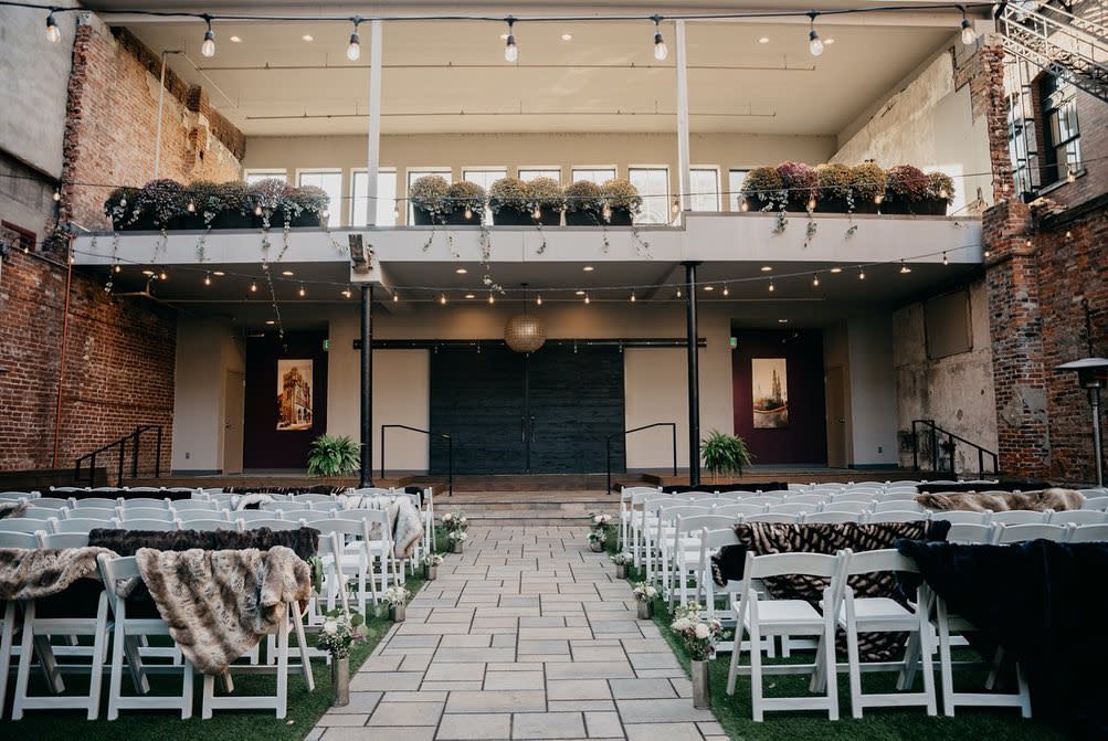 Courtyard of Hotel Covington set up for a wedding reception with an alter at the end.