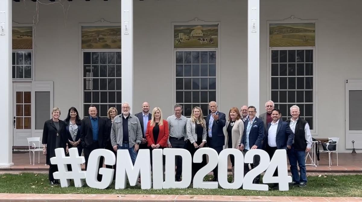 The Visit Albuquerque Board stands behind foam letters that spell #GMID2024