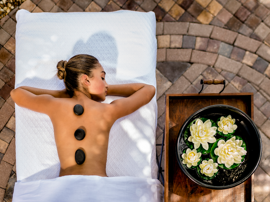 woman relaxing with hot stones