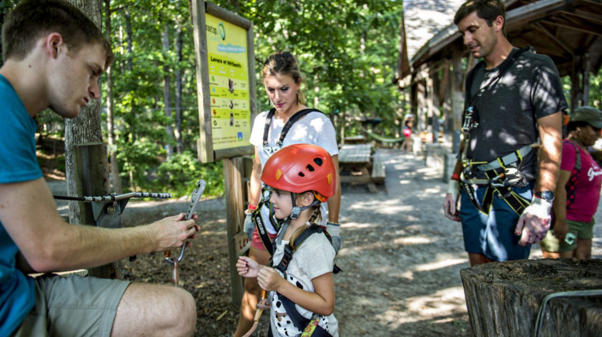 man showing girl safety hook