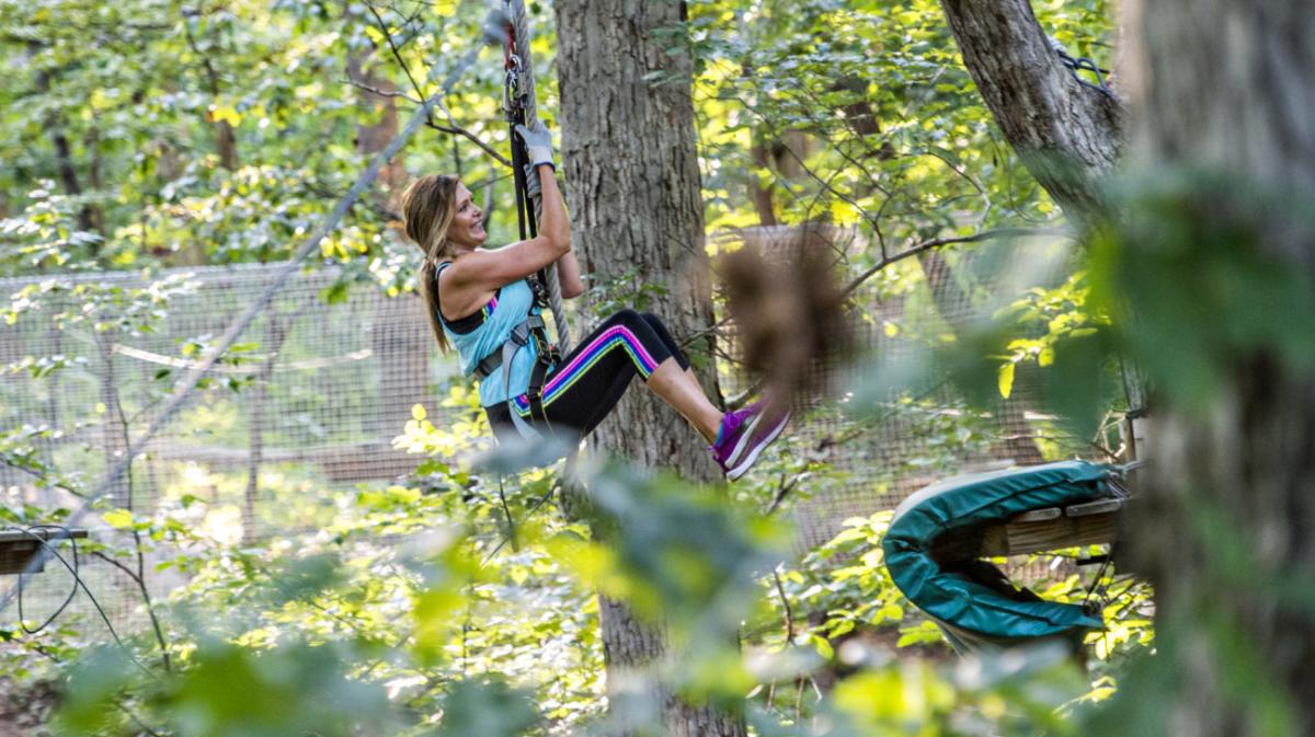 woman swinging from tree rope