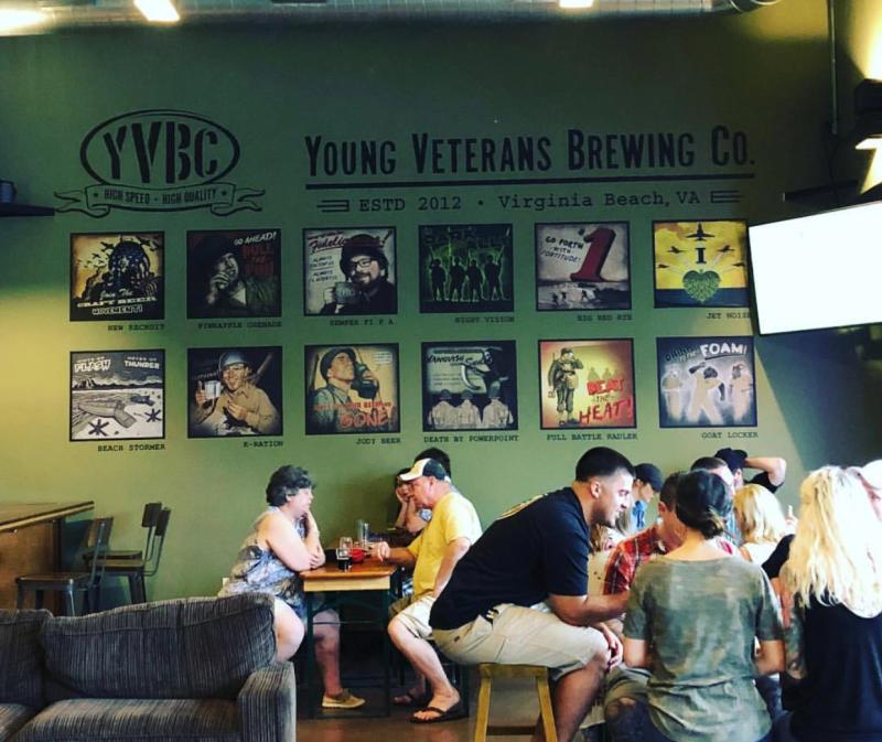 People sitting at tables in a brewery