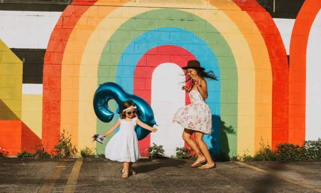 Girls frolic in front of Cbus Color Wall mural
