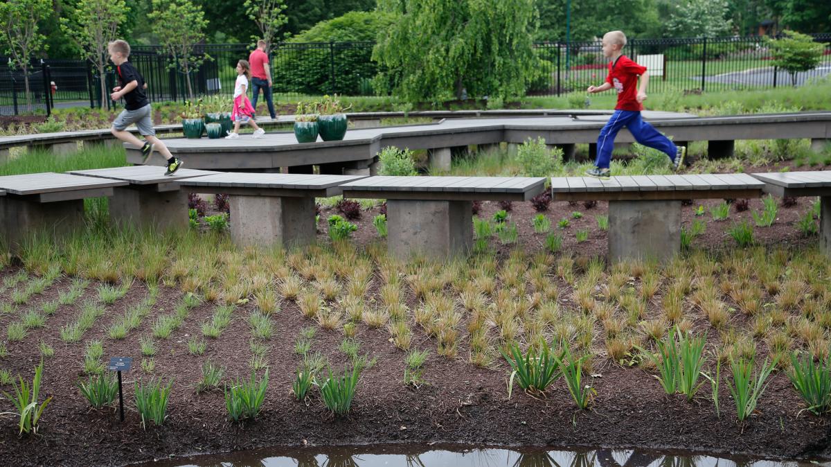 Kids cross the walkway at wetland explore at The Scotts Miracle-Gro Foundation Children’s Garden at Franklin Park Conservatory