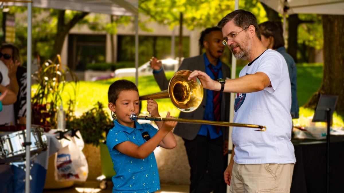 Boy playing trombone at Taste of the Arts