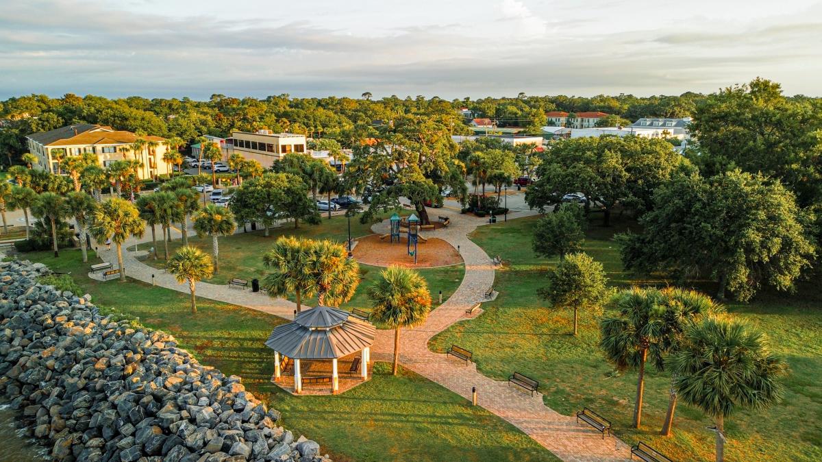 An aerial view of Neptune Park and Pier Village on St. Simons Island, GA.