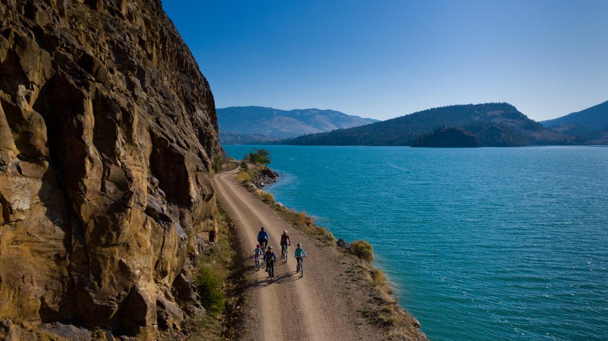 People Biking Along A Cliff In Kelowna, BC