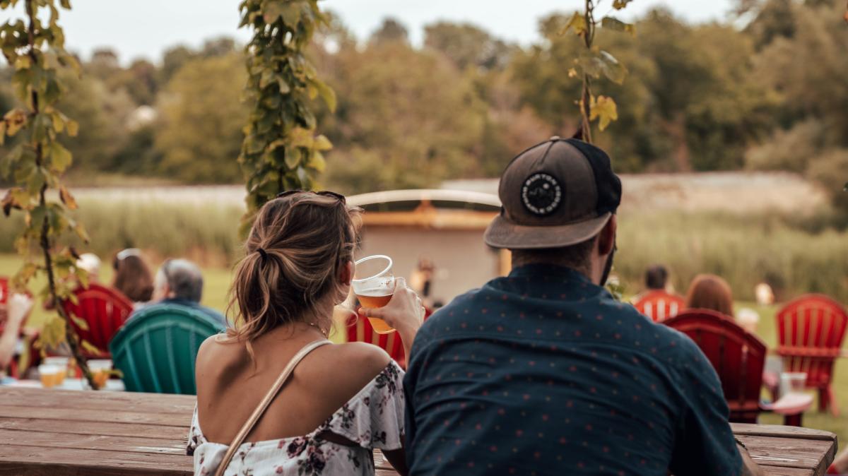 Back of woman and man drinking beer