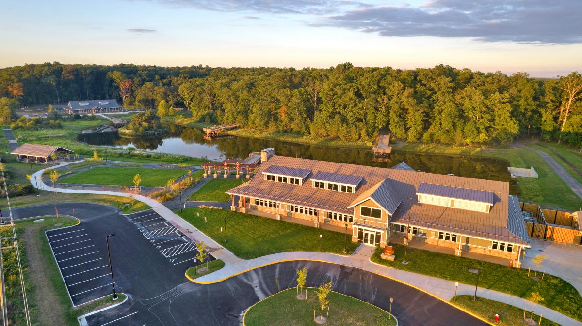 Aerial view of the main recreation building at Hal and Berni Hanson Regional Park surrounded by lush greenery in Aldie, Virginia