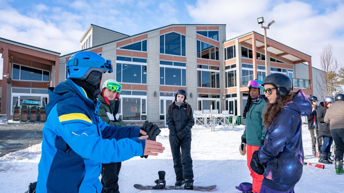 A group of skiers taking lessons at a ski school