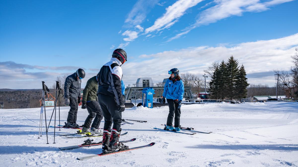 A group of skiers taking lessons at a ski school