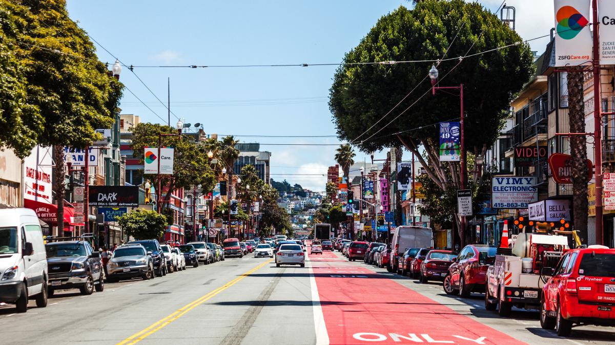 Cars and restaurants line the street in San Francisco's Mission District.