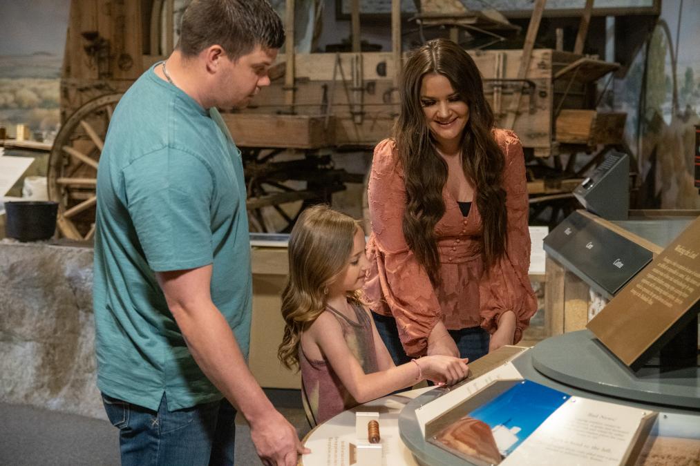 A Family exploring a western exhibit at Panhandle-Plains Museum located in Canyon, Texas