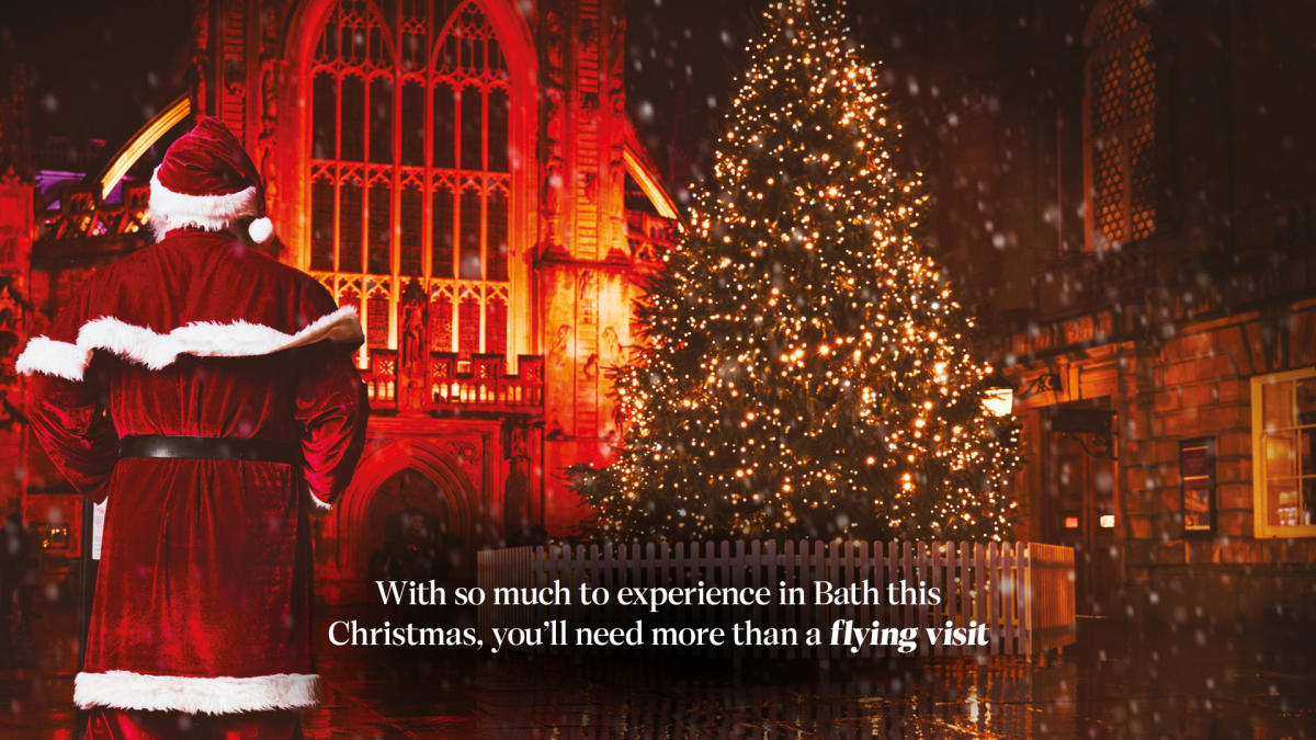 Bath at Christmas campaign image of Father Christmas at Bath Abbey with text CREDIT Bath at Christmas, credit Stuff Creative Studio & Adam Gasson