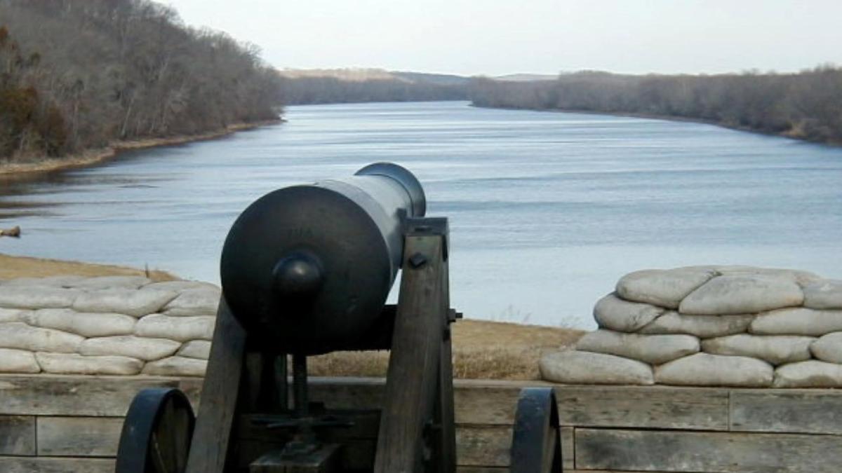 cannon looking over a river