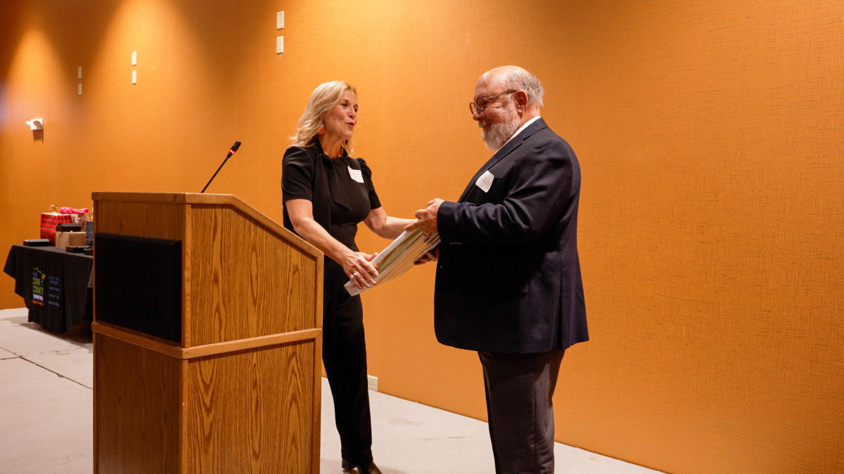 Linda Jurek presents Jim Boyd with a gift celebrating his retirement after years of service to the Chamber