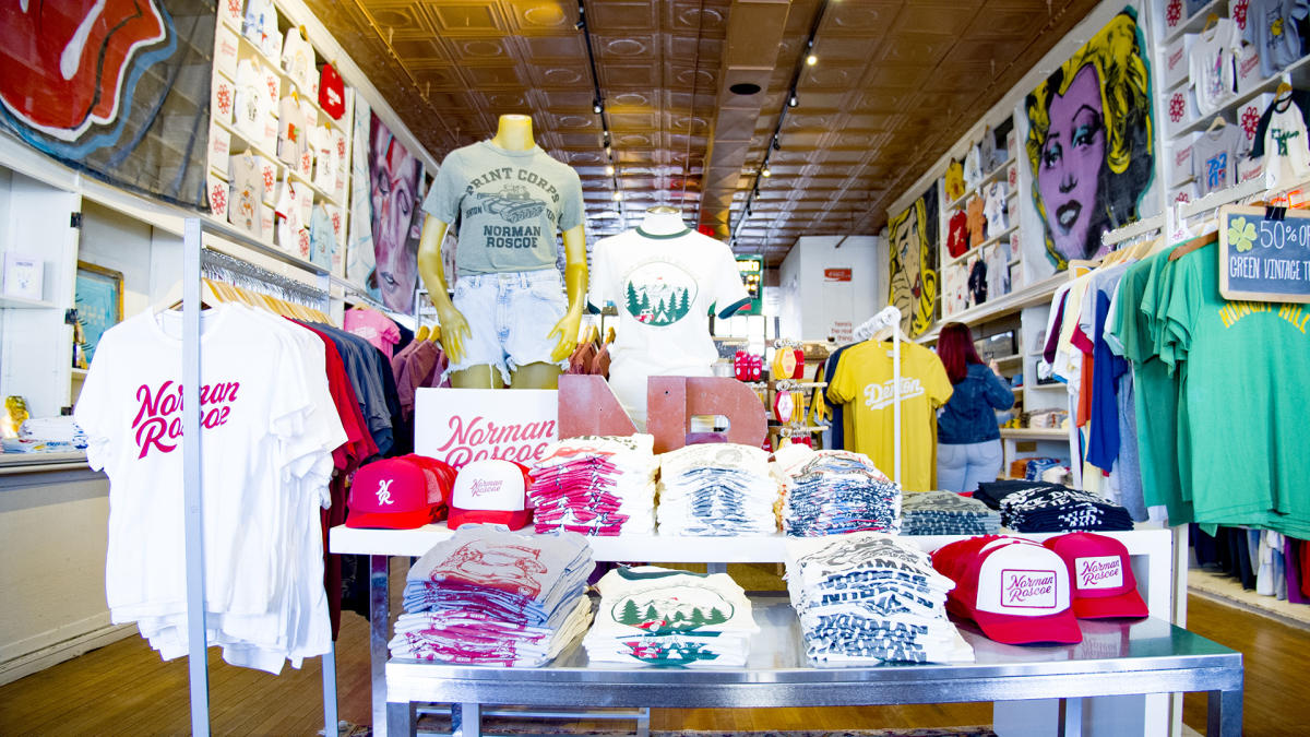 A shop display of t-shirts and hats in Norman Roscoe