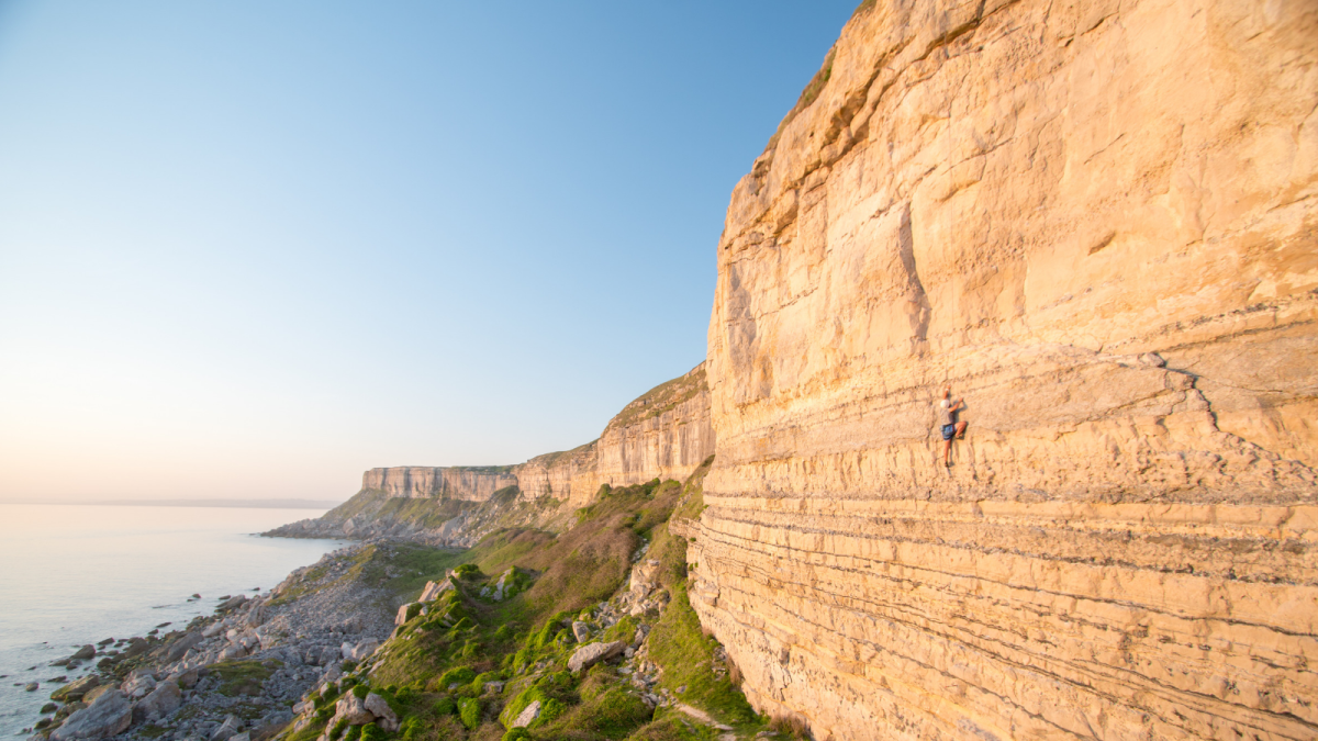 Person rock climbing on the Isle of Portland in Dorset