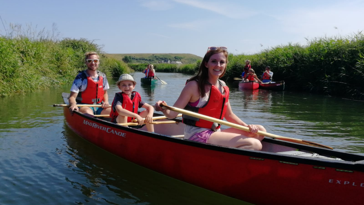 Family paddling up the river Britt with West Bay Canoes