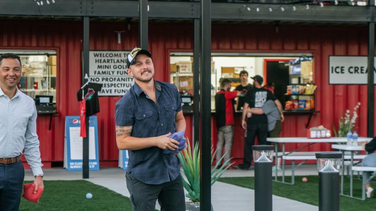 a man palying yard game at heartland mini golf