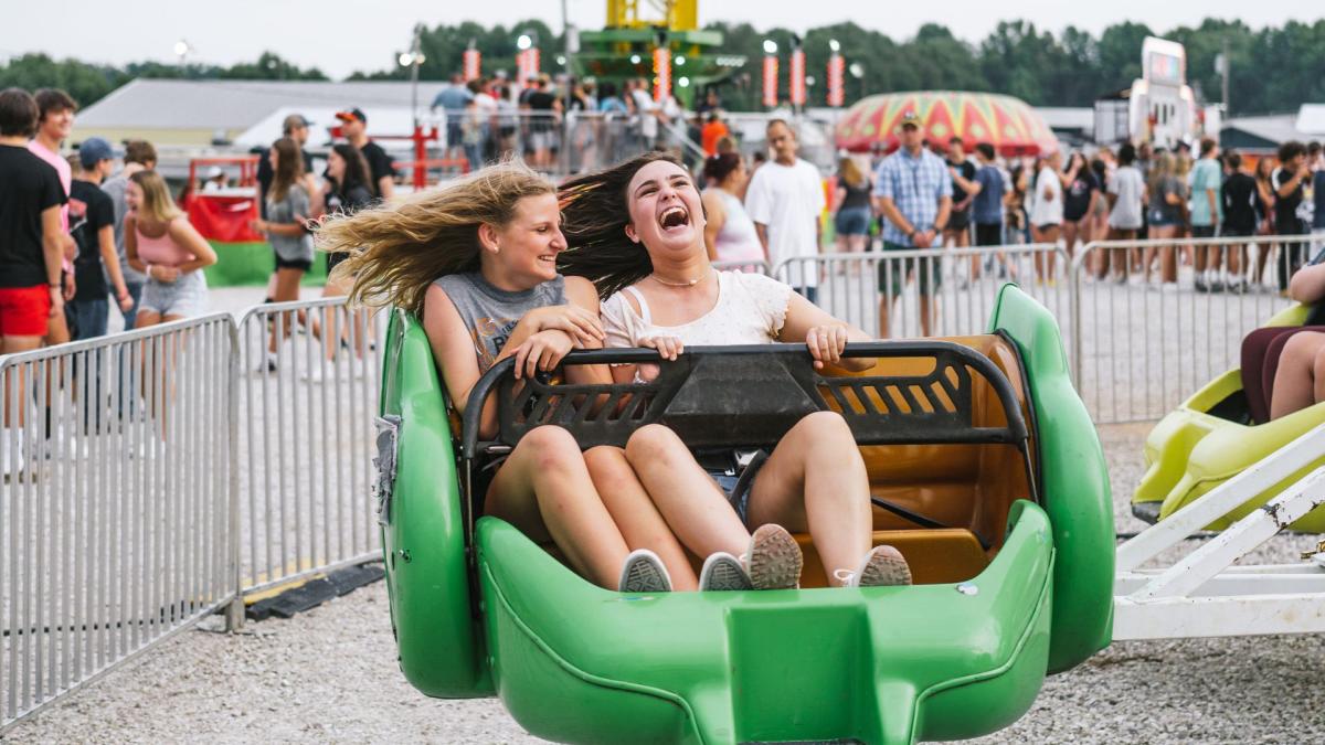 two girls enjoying a ride at the county fair