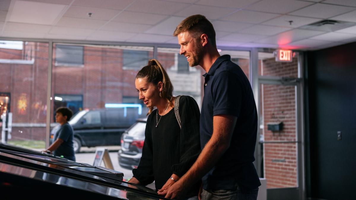 a couple playing arcade games a 3 decade arcade