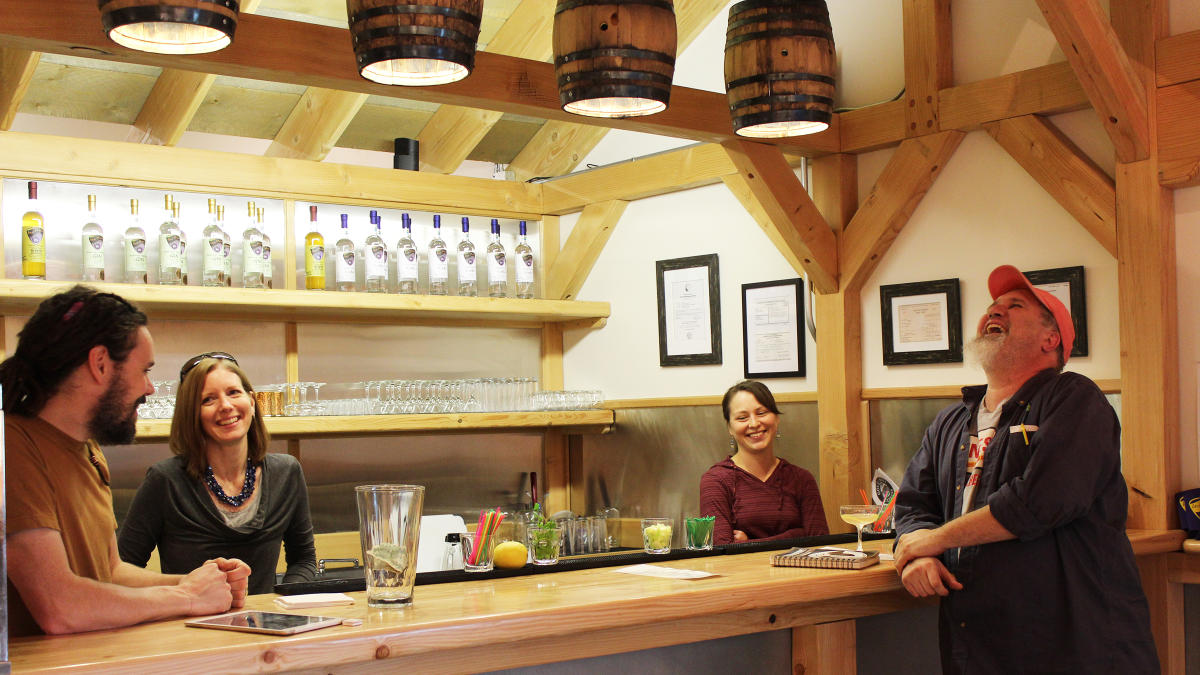Patrons gathered around the bar at Ursa Major, laughing and enjoying their time together.