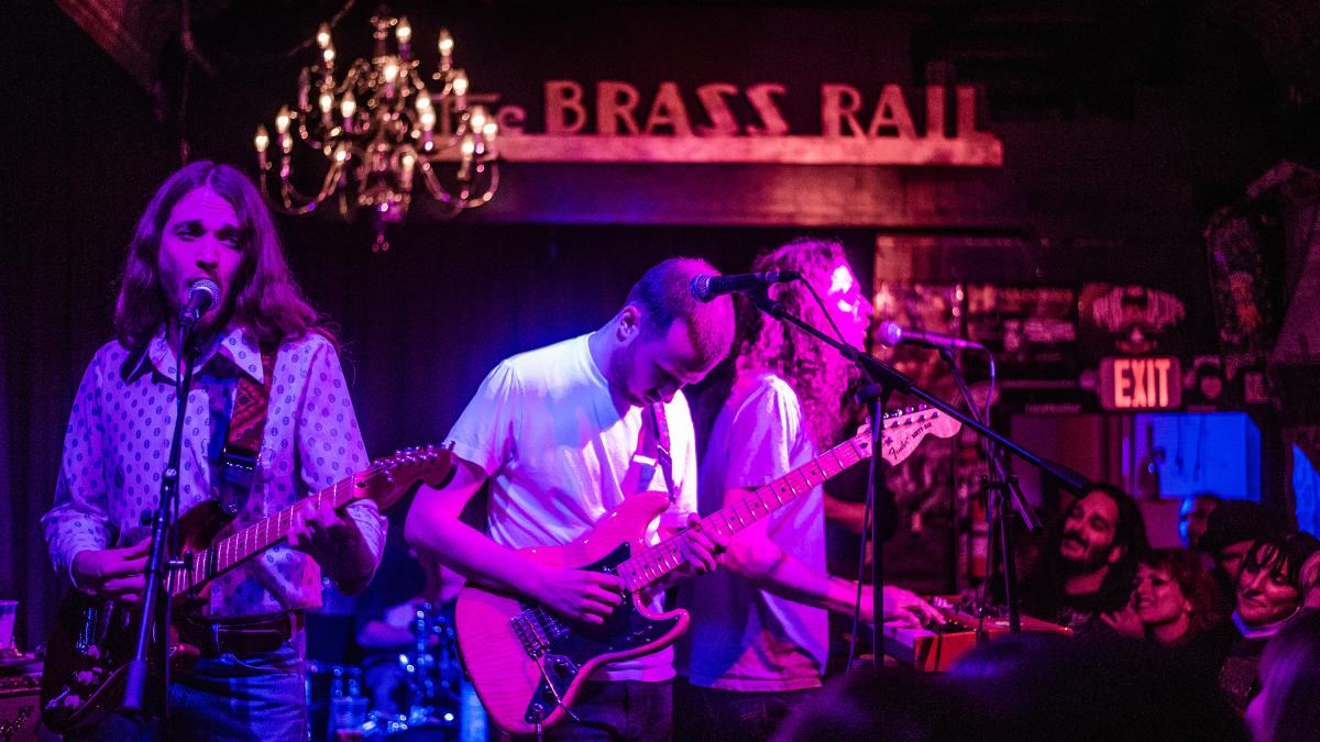 Band playing in dark lighting at the Brass Rail