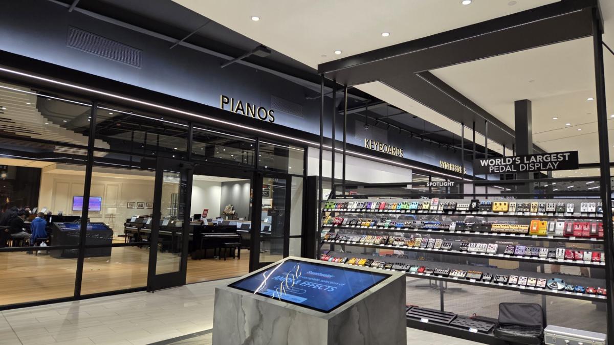 Interior of Sweetwater Sound music store showing the piano section