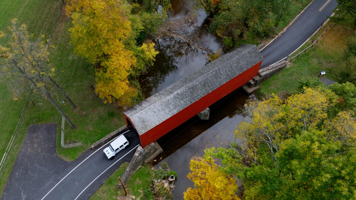 Car coming from a Covered Bridge 