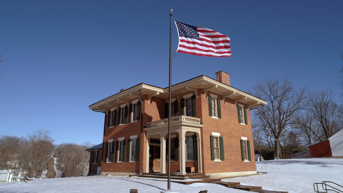 Brick home of Ulysses S. Grant, with an American flag flying in the front, during winter.