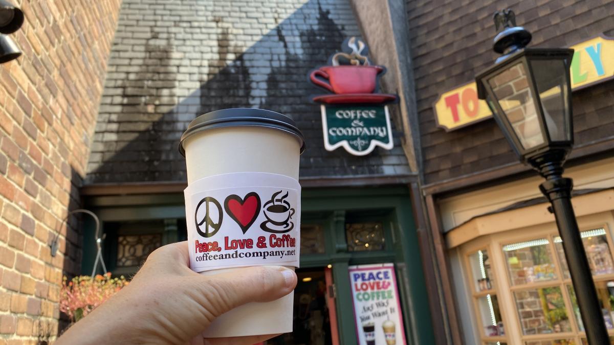 Man Holding Coffee Cup From Coffee & Company