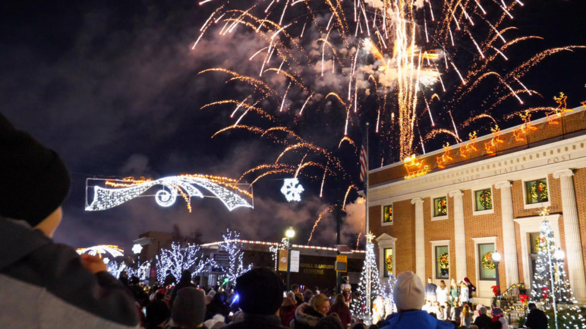 Fireworks go up over the brick City Office building in downtown Cedar City above bright and snowy holiday lights for the downtown lighting events.