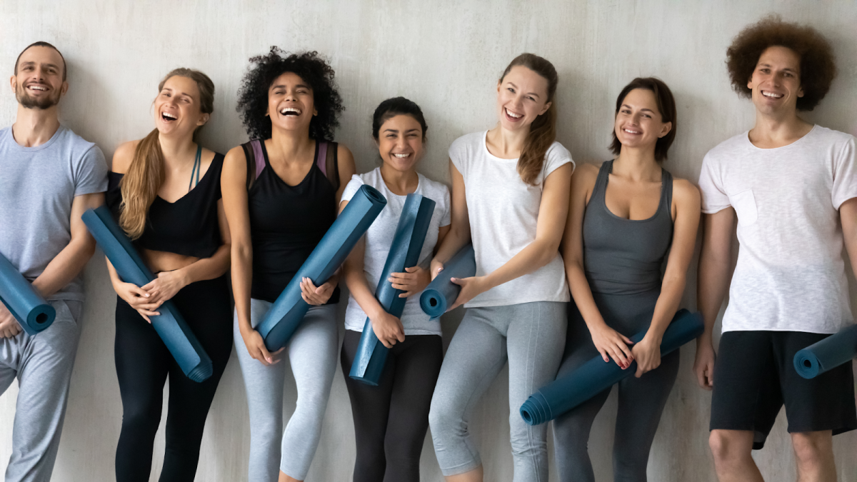 Group of People with Yoga Mats Laughing